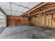 Interior view of a garage showing exposed framing, a concrete floor, and shelving at 3427 Donald Ave, Indianapolis, IN 46224