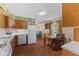 Cozy kitchen features classic wood cabinetry and adjacent dining area with lots of natural light at 3427 Donald Ave, Indianapolis, IN 46224