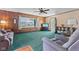 Inviting living room features wood paneling, ceiling fan and a large window that brightens the space at 3427 Donald Ave, Indianapolis, IN 46224