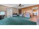 Bright living room features wood paneling, ceiling fan, and easy access to outside at 3427 Donald Ave, Indianapolis, IN 46224