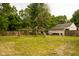 Spacious backyard with a wooden playset, swing, slide, and ample green space at 3431 W Mooresville Rd, Indianapolis, IN 46221