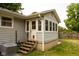 Backyard porch with wooden steps, siding, and a view of the surrounding yard at 3431 W Mooresville Rd, Indianapolis, IN 46221