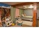 Playful basement bedroom features a whimsical mural, twin bed, and assorted toys at 3431 W Mooresville Rd, Indianapolis, IN 46221