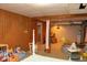 Finished basement featuring wood paneling, a crawl space, and ample storage space at 3431 W Mooresville Rd, Indianapolis, IN 46221