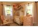 Adorable Bedroom with a crib, rocking chair, and dresser, perfect for a new baby at 3431 W Mooresville Rd, Indianapolis, IN 46221