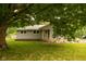 Charming single-story home with mature tree offering ample shade in a well-maintained yard at 3431 W Mooresville Rd, Indianapolis, IN 46221