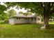 Charming single-story home with mature tree and a welcoming swing in a well-maintained yard at 3431 W Mooresville Rd, Indianapolis, IN 46221