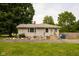 Cozy single-story home featuring well-kept lawn and rock garden at 3431 W Mooresville Rd, Indianapolis, IN 46221
