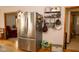 Stainless steel refrigerator surrounded by pantry and doorway views to other rooms at 3431 W Mooresville Rd, Indianapolis, IN 46221