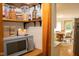 Well-organized pantry featuring open shelves and nearby kitchen with microwave and dining area at 3431 W Mooresville Rd, Indianapolis, IN 46221