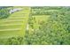 Expansive rural property showcasing lush landscapes with a home surrounded by greenery and a pond at 3512 N Wakeland Rd, Paragon, IN 46166