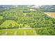 Secluded country property featuring a home surrounded by dense woodland and rolling fields at 3512 N Wakeland Rd, Paragon, IN 46166