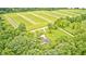 Idyllic country setting with charming home surrounded by lush greenery and open fields at 3512 N Wakeland Rd, Paragon, IN 46166