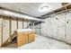 Unfinished basement featuring cement walls, flooring, duct work, a cabinet and hanging exposed ceiling at 3512 N Wakeland Rd, Paragon, IN 46166