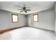 Neutral bedroom with wood-look floors, natural light from two windows, and a ceiling fan at 3512 N Wakeland Rd, Paragon, IN 46166