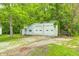 Exterior view of the detached garage with two bay doors surrounded by a grassy lawn at 3512 N Wakeland Rd, Paragon, IN 46166