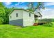 Exterior view of the house with a backyard deck overlooking the grass, lush green trees, and foliage at 3512 N Wakeland Rd, Paragon, IN 46166