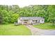 Charming single-story home with a cozy front porch and lush landscaping at 3512 N Wakeland Rd, Paragon, IN 46166
