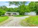 Charming single-story home with a covered porch, detached garage, and a lush green surroundings at 3512 N Wakeland Rd, Paragon, IN 46166
