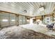 Spacious open garage featuring cement floors, shelving, two doors, exposed beams and an open overhead door at 3512 N Wakeland Rd, Paragon, IN 46166