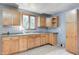 Functional kitchen with classic wood cabinets, a double basin sink, and natural light from a nearby window at 3512 N Wakeland Rd, Paragon, IN 46166