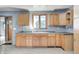 Classic kitchen featuring wood cabinets, a double basin sink, and a view to an adjacent living space at 3512 N Wakeland Rd, Paragon, IN 46166