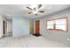 Bright living room featuring wood-look floors, a ceiling fan, and a large window for ample natural light at 3512 N Wakeland Rd, Paragon, IN 46166
