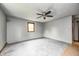 Spacious living room with gray walls, light gray flooring, and a ceiling fan with a light fixture at 3512 N Wakeland Rd, Paragon, IN 46166