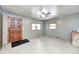 Inviting living room with wood-look floors, a ceiling fan, stone fireplace, and abundant natural light at 3512 N Wakeland Rd, Paragon, IN 46166