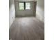Bedroom with hardwood floors, and windows that provide ample natural lighting, walls are ready for paint at 3526 Evergreen Ave, Indianapolis, IN 46205