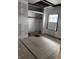 Bedroom space featuring unfinished floors, an open closet area, and a window for natural lighting at 3526 Evergreen Ave, Indianapolis, IN 46205