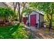 Backyard featuring storage sheds and well maintained landscaping at 3533 Alexandria Pike, Anderson, IN 46012
