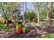 Secluded backyard setting with stone pathway, mature trees, and inviting seating areas at 3533 Alexandria Pike, Anderson, IN 46012