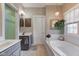 Relaxing bathroom featuring a soaking tub, dual vanities, and decorative accents at 3533 Alexandria Pike, Anderson, IN 46012