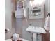 Charming powder room features a pedestal sink, decorative mirror, and elegant wall decor at 3533 Alexandria Pike, Anderson, IN 46012