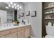 Bathroom featuring double vanity, vanity storage, decorative art, and a separated toilet at 3533 Alexandria Pike, Anderson, IN 46012