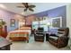 Comfortable bedroom with a ceiling fan, upholstered chairs, and soft natural light at 3533 Alexandria Pike, Anderson, IN 46012