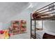 Fun bedroom featuring a bunk bed, carpet, slanting ceiling, and toy storage shelves at 3533 Alexandria Pike, Anderson, IN 46012
