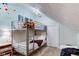 Cozy bedroom featuring bunk beds, carpet, and a unique slanted ceiling at 3533 Alexandria Pike, Anderson, IN 46012