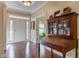 Charming foyer with hardwood floors, a decorative cabinet, and a view to the front door and a seating area at 3533 Alexandria Pike, Anderson, IN 46012