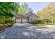 Home featuring a spacious three-car garage with ample parking and landscaped surroundings at 3533 Alexandria Pike, Anderson, IN 46012