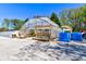 Wide exterior shot of a greenhouse covered in plastic with plants inside and gravel surrounding at 3533 Alexandria Pike, Anderson, IN 46012