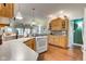 Bright kitchen featuring white appliances, wood cabinets, and hardwood floors at 3533 Alexandria Pike, Anderson, IN 46012