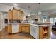 Well-lit kitchen featuring wood cabinets, tiled backsplash, and modern appliances at 3533 Alexandria Pike, Anderson, IN 46012