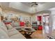 Inviting living room with hardwood floors, a comfortable sofa, and a view into the kitchen and dining area at 3533 Alexandria Pike, Anderson, IN 46012