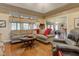 Bright living room featuring hardwood floors, large windows, comfortable seating, and an open layout to the kitchen at 3533 Alexandria Pike, Anderson, IN 46012