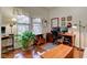 Bright office with hardwood floors, two windows, and built in drawers provides ample storage space at 3533 Alexandria Pike, Anderson, IN 46012