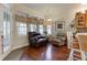Cozy sitting area with hardwood floors, large windows, and comfortable seating with a view of the yard at 3533 Alexandria Pike, Anderson, IN 46012