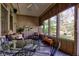 Enclosed sunroom featuring dining and seating areas, providing an inviting space to relax and entertain at 3533 Alexandria Pike, Anderson, IN 46012
