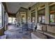 Cozy sunroom with a dining area, comfortable seating, and ample natural light from the large windows at 3533 Alexandria Pike, Anderson, IN 46012
